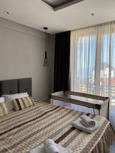 a bedroom with two beds and a window at Milmari Premier 28 Kopaonik in Kopaonik
