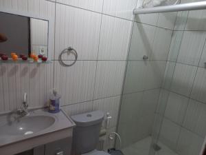 a bathroom with a shower and a toilet and a sink at Chácara Família Nacer in Serra de São Bento +33 photos