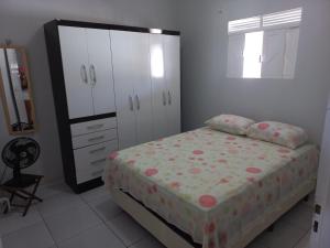 a bedroom with a bed and a dresser and a mirror at Chácara Família Nacer in Serra de São Bento