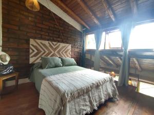a bedroom with a bed and a brick wall at Bungalows Luz del sur in San Carlos de Bariloche