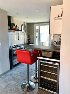 cocina con barra y taburete rojo en Appartement T3 - 70m² - L'Espérance, en La Seyne-sur-Mer