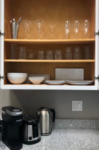 a cupboard with plates and bowls and glasses on it at Petaluma Warehouse Lofts, Unit B in Petaluma