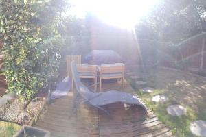 a table and two chairs sitting on a wooden deck at 3 Bedroom 3 Bathroom House, Dublin in Lucan