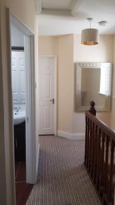 a hallway with a bathroom with a sink and a mirror at 3 Bedroom 3 Bathroom House, Dublin in Lucan