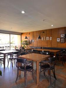 a dining room with wooden tables and chairs at Towers Confort in Rionegro