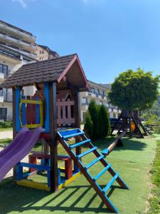 a playground with a slide and a play structure at Milmari Premier 28 Kopaonik in Kopaonik
