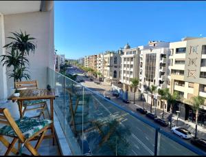a balcony with a view of a city with buildings at Studio ALMASSIRA in Casablanca