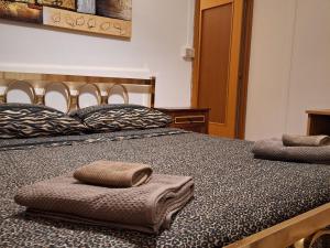 sypialnia z 2 łóżkami i ręcznikami w obiekcie Michelle Apartment w mieście Bari