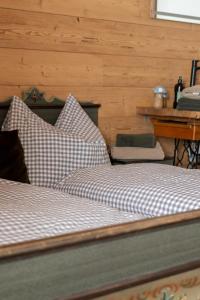 a bedroom with two beds and a table and a desk at Peer Alm in Navis