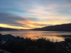 a view of a large body of water at sunset at Otago Peninsula Paradise in Dunedin