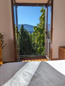 a room with a door open to a balcony with a view at Piso Grande La Viña in Biescas
