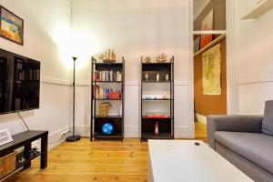a living room with a couch and a table at Ambiente Hostel in Lisbon