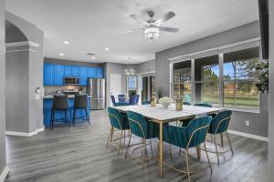 a kitchen and dining room with a table and chairs at Themed Luxury 6BR Getaway with Resort Amenities in Orlando