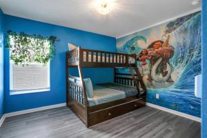 a childs room with two bunk beds and a mural at Themed Luxury 6BR Getaway with Resort Amenities in Orlando