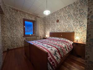 Een bed of bedden in een kamer bij Casa Cercenà - Soggiorna nel cuore delle Dolomiti!