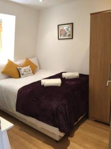 a bedroom with a bed with two towels on it at Lovely Private Bedrooms in Euston Station - 121 in London