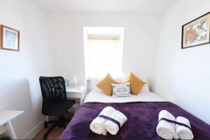 a bedroom with a bed and a desk and a window at Lovely Private Bedrooms in Euston Station - 121 in London