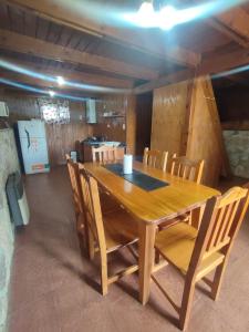 a wooden table and chairs in a room at La cumbrecita village in La Cumbrecita
