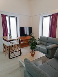 a living room with a couch and a table at Apartamentos turisticos Ávila Puerta del Carmen 0-3 in Avila