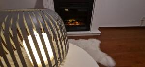 a fire in a fireplace in a living room at Tatra diamond appartement 70m2 v centre s parkovanim zadarmo in Poprad