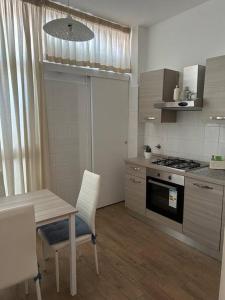 a kitchen with a table and a table and a stove at Federica Apartment in Palermo