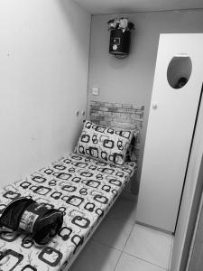 a black and white photo of a bench in a room at The Hosteller in Dubai