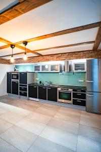 a kitchen with black cabinets and stainless steel appliances at Designhaus - Whirlpool - 180qm2 - Garage - 2 Etagen in Rüdesheim am Rhein