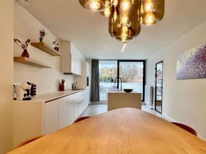 a kitchen with a large wooden table in a room at Surmont 52 in Ieper