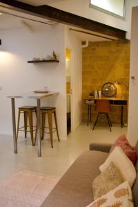 ein Wohnzimmer mit einem Sofa und einem Tisch in der Unterkunft Joli studio avec terrasse-jardin sur les toits, coeur historique in Montpellier