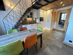 a kitchen with a wooden table and chairs at TIGNES VAL CLARET A LA CONQUETE DES SOMMETS 314 in Tignes