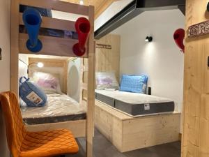 a room with two bunk beds and a chair at TIGNES VAL CLARET A LA CONQUETE DES SOMMETS 314 in Tignes