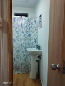 baño con lavabo y cortina de ducha en Cabañas Janico, en Loncoche