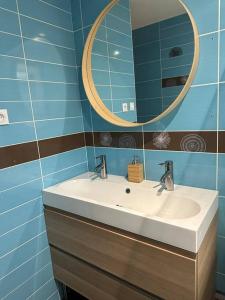 a bathroom with a sink and a mirror at Comme à la maison… in Pusignan