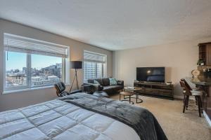 a bedroom with a large bed and a television at Quiet Efficiency Condo - Downtown Minneapolis in Minneapolis