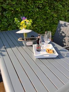 una mesa de picnic con copas de vino y un plato de comida en Gîte Libre’Air en Redu
