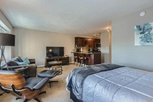 a bedroom with a bed and a living room at Quiet Efficiency Condo - Downtown Minneapolis in Minneapolis