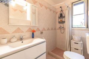 a bathroom with a sink and a toilet at Villa De Santis Relax e Natura a Gallipoli in Gallipoli