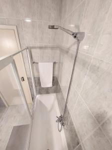 a shower with a glass door in a bathroom at Fortaleza Faro in Valença