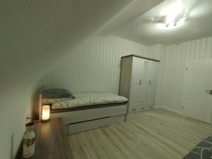 a bedroom with a bed and a cabinet at Nah an Mercedes-Werke in Stuttgart