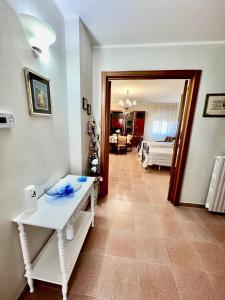 a room with a white table and a living room at Appartamento Gardenia in Nardò