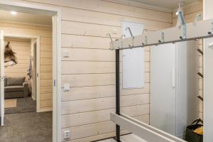 a room with wooden walls and a mirror at Holy Moly by Hilla Villas in Pelkosenniemi +30 photos