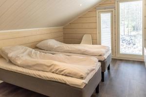 two beds in a room with a attic at Holy Moly in Pelkosenniemi