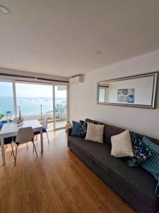 a living room with a couch and a table with a view at Casa dos Cotas - Amazing Seaside Apartment with Balcony in Cascais