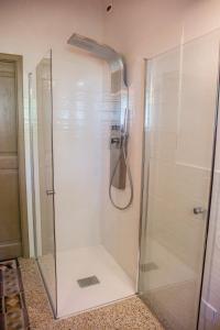 a shower with a glass door in a bathroom at Agriturismo Bellarosa in Albinea