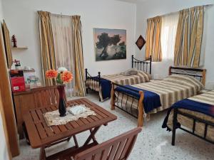 a living room with two beds and a table at Saracini's Homestay - 156, Emerald in Attard