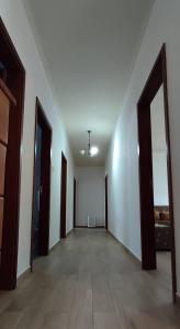 an empty hallway with two open doors and a room with at Apartamento da Matilde in Santa Cruz das Flores