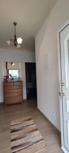 an empty living room with a door and a rug at Apartamento da Matilde in Santa Cruz das Flores