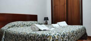 a bed with two pillows on top of it at Apartamento da Matilde in Santa Cruz das Flores