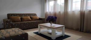 a living room with a couch and a table at Apartamento da Matilde in Santa Cruz das Flores +13 photos