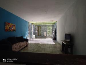 a living room with a couch and a door to a hallway at Marbelo Pernambuco Hostel in Recife